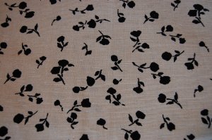 A very early 1950s' linen, petite black flower silhouettes on a pale ecru background.